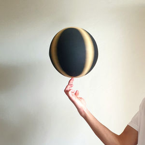 Midsection of woman holding balloons against white background