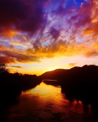 Scenic view of lake against romantic sky at sunset