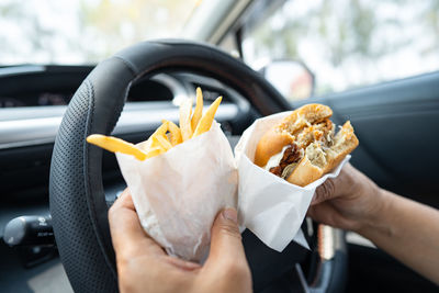 Cropped hand of person holding food