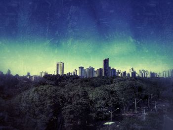 View of cityscape against blue sky