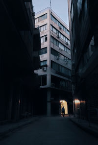 People walking on street amidst buildings in city