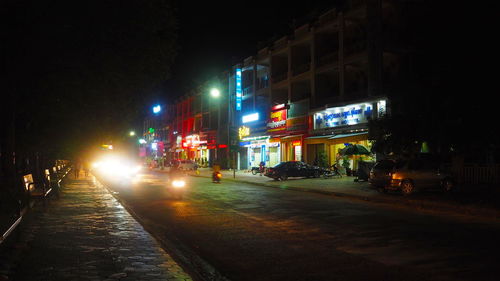 City street amidst buildings at night