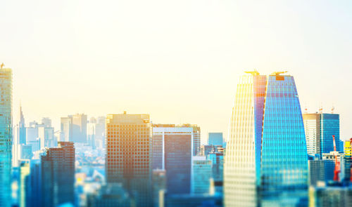 Modern buildings in city against clear sky