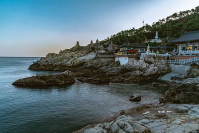 Scenic view of temple on the beach against sky