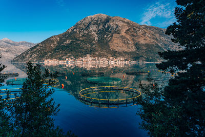 High angle view of lake and buildings against blue sky