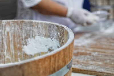 Close-up of person preparing food on table