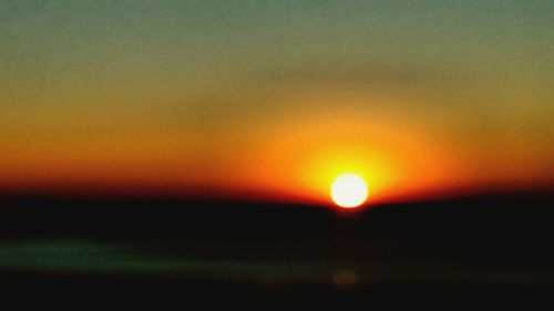 Silhouette landscape against sky during sunset