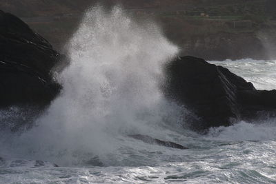 Close-up of waves breaking against sea