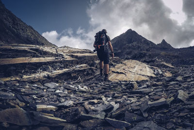 Man hiker going to mountain peak italy alps