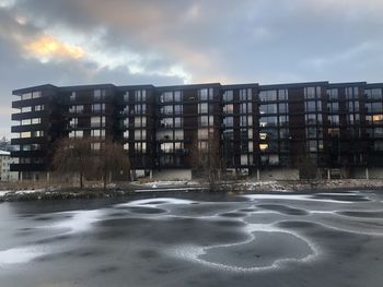 Buildings in city against sky during winter