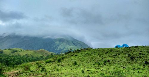 Scenic view of famous trek kumaraparvata mountain western ghats, india with camping tents and clouds