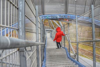 Rear view of woman walking on steps