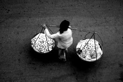 Rear view of boy holding umbrella