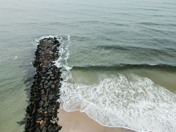 High angle view of sea waves splashing on shore