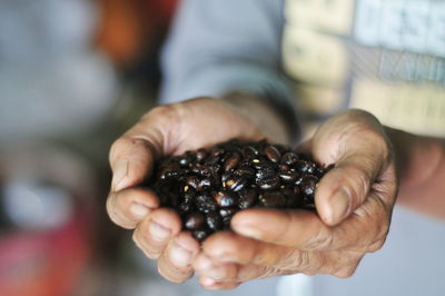 Midsection of man holding ice cream