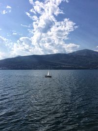 Sailboat sailing on sea against sky