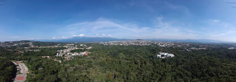 Landscape and townscape against blue sky