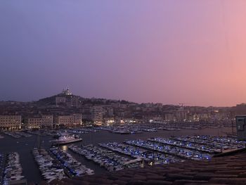 High angle view of illuminated buildings against sky at dusk