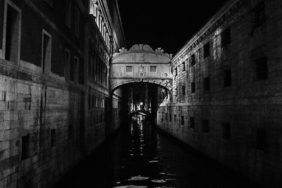 Illuminated bridge at night