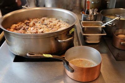 Food cooking in container on stove at kitchen