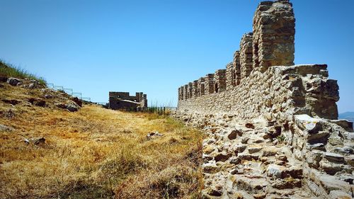 Low angle view of old building against clear blue sky