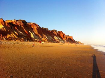 Scenic view of beach against clear blue sky