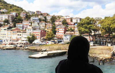 Rear view of silhouette woman looking at river