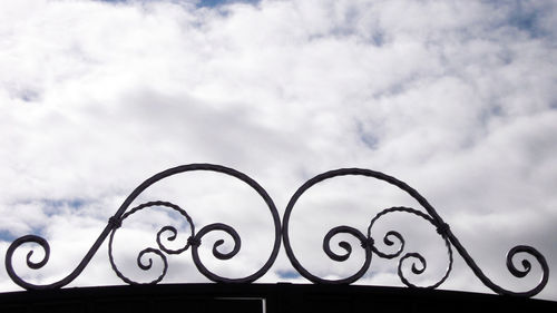 Low angle view of metal against sky