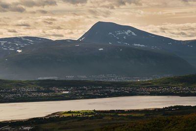 Scenic view of lake and mountains against sky