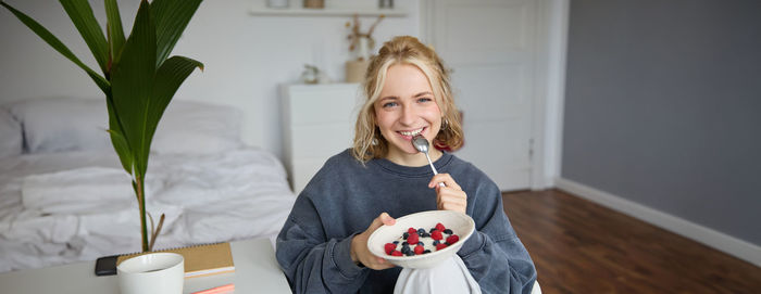 Portrait of young woman using mobile phone