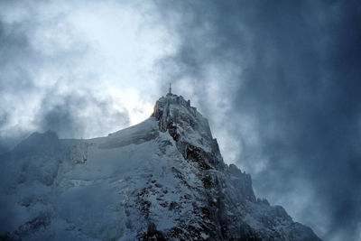 Low angle view of snowcapped mountain against sky