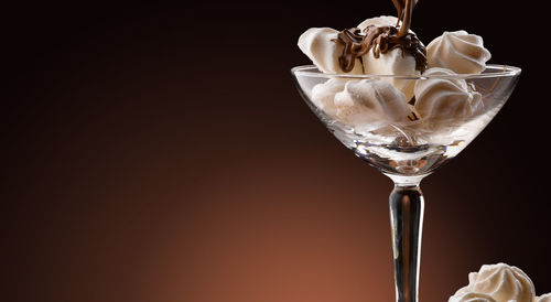 Close-up of wine glass against black background