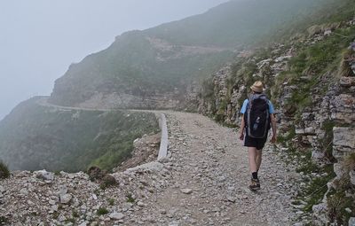 Rear view of man walking on mountain
