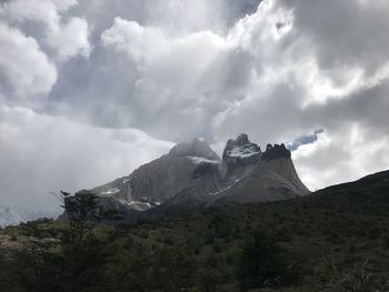 Scenic view of mountains against cloudy sky