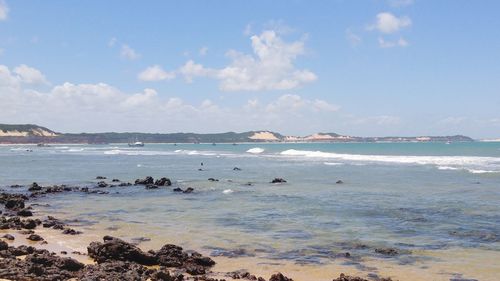 Scenic view of sea against cloudy sky