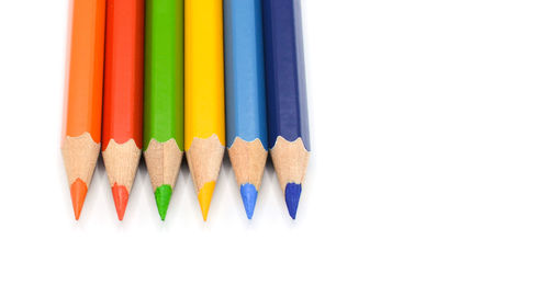 Close-up of colored pencils against white background