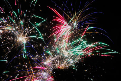 Low angle view of firework display at night