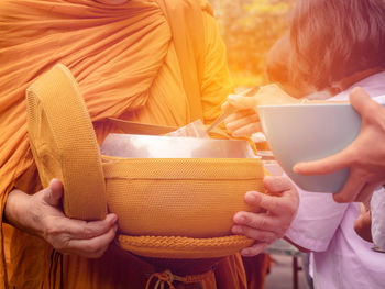 Midsection of couple holding basket