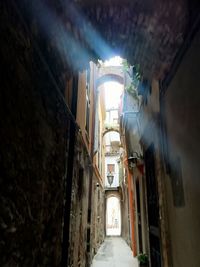 Low angle view of narrow alley amidst buildings