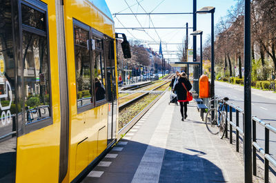 Yellow tram at station in a sunny day