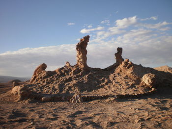 Lizard on rock against sky