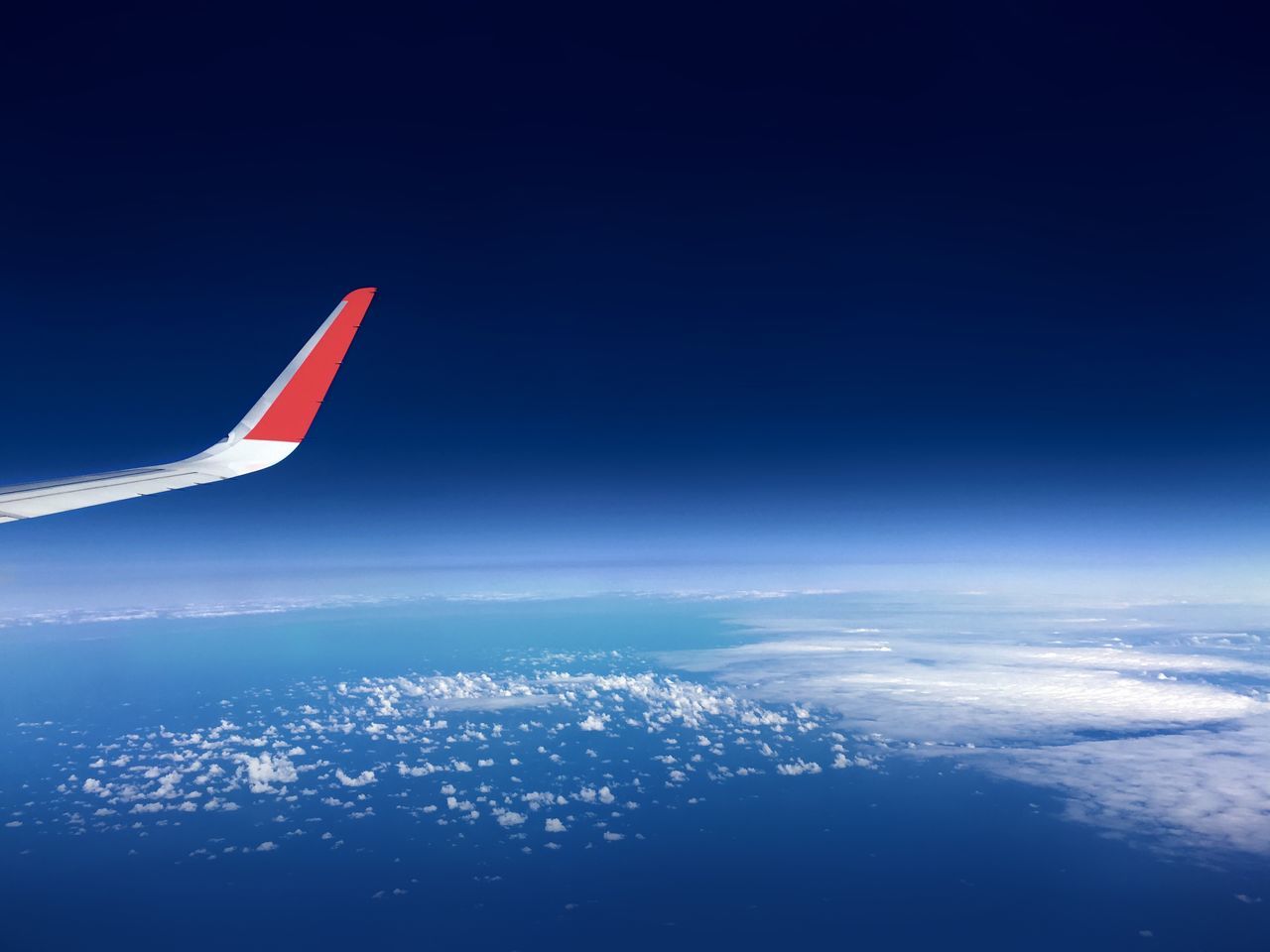 AERIAL VIEW OF CLOUDSCAPE OVER AIRPLANE