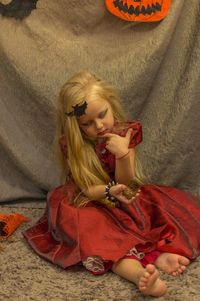 Young woman sitting on bed at home