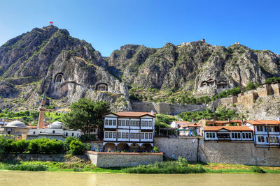 Houses on mountain against sky