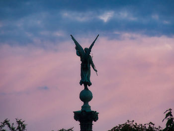 Low angle view of statue against sky during sunset