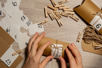 Cropped hands of woman using mobile phone on table