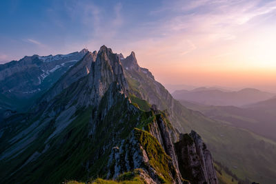 Panoramic view of snowcapped mountains against sky during sunset