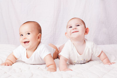 Portrait of cute baby lying on bed