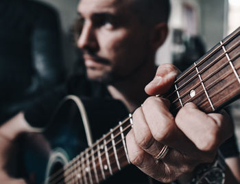 Cropped image of man playing guitar