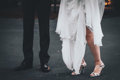 Low section of women standing on street